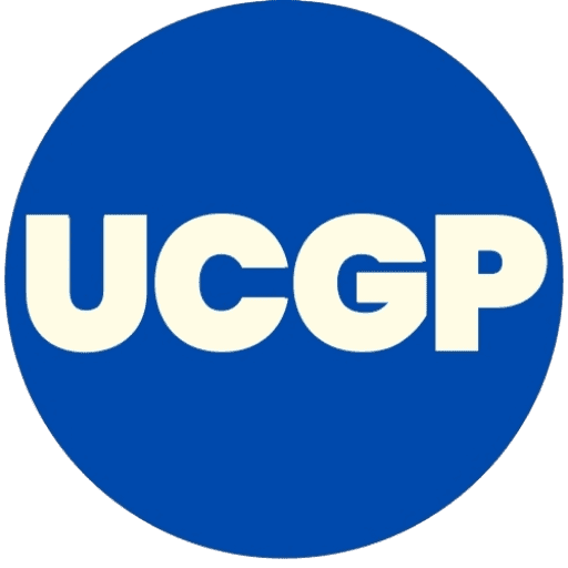 UpcomingGamespot.com UCGP circular acronym logo featuring bold, off-white text inside a solid blue circle for gaming platform branding.